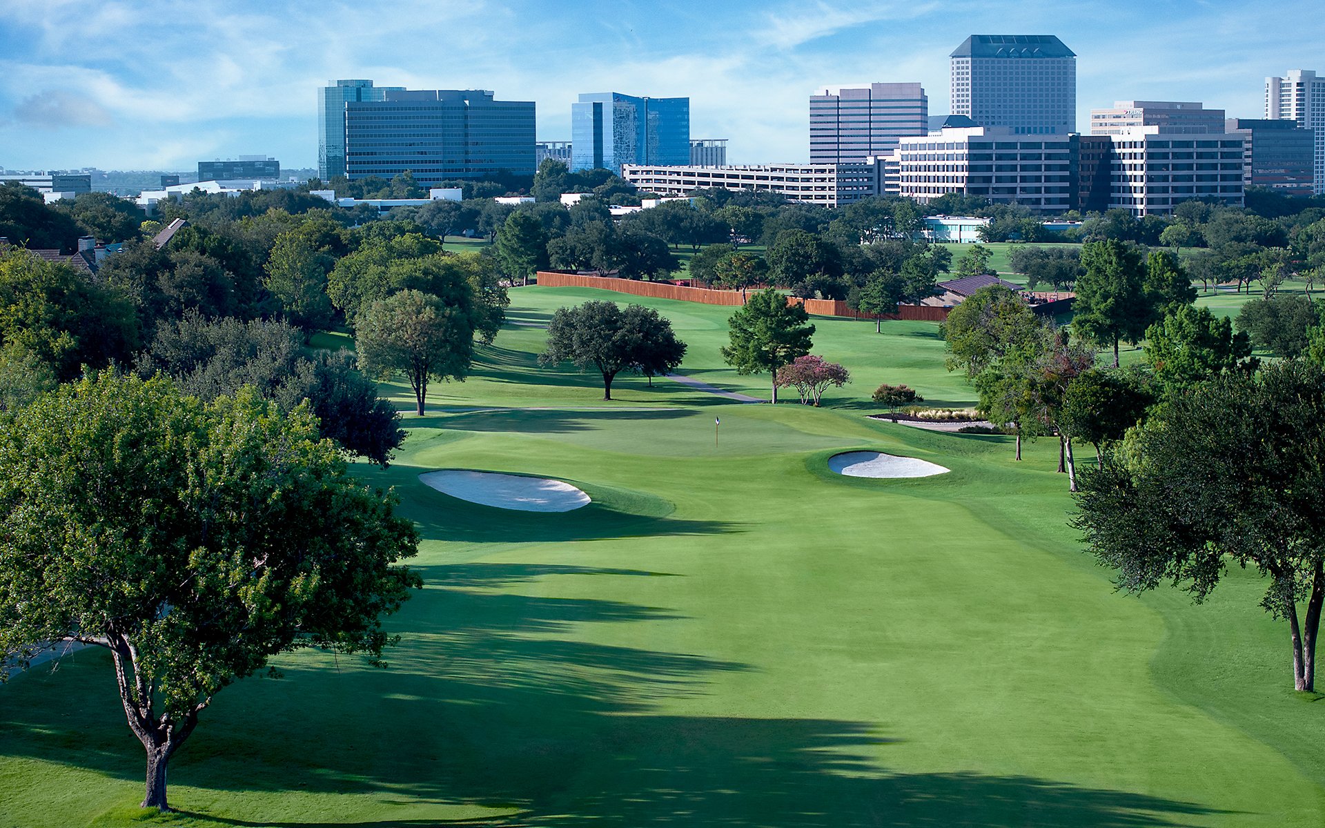 Aerial view of fairway and green with water hazards